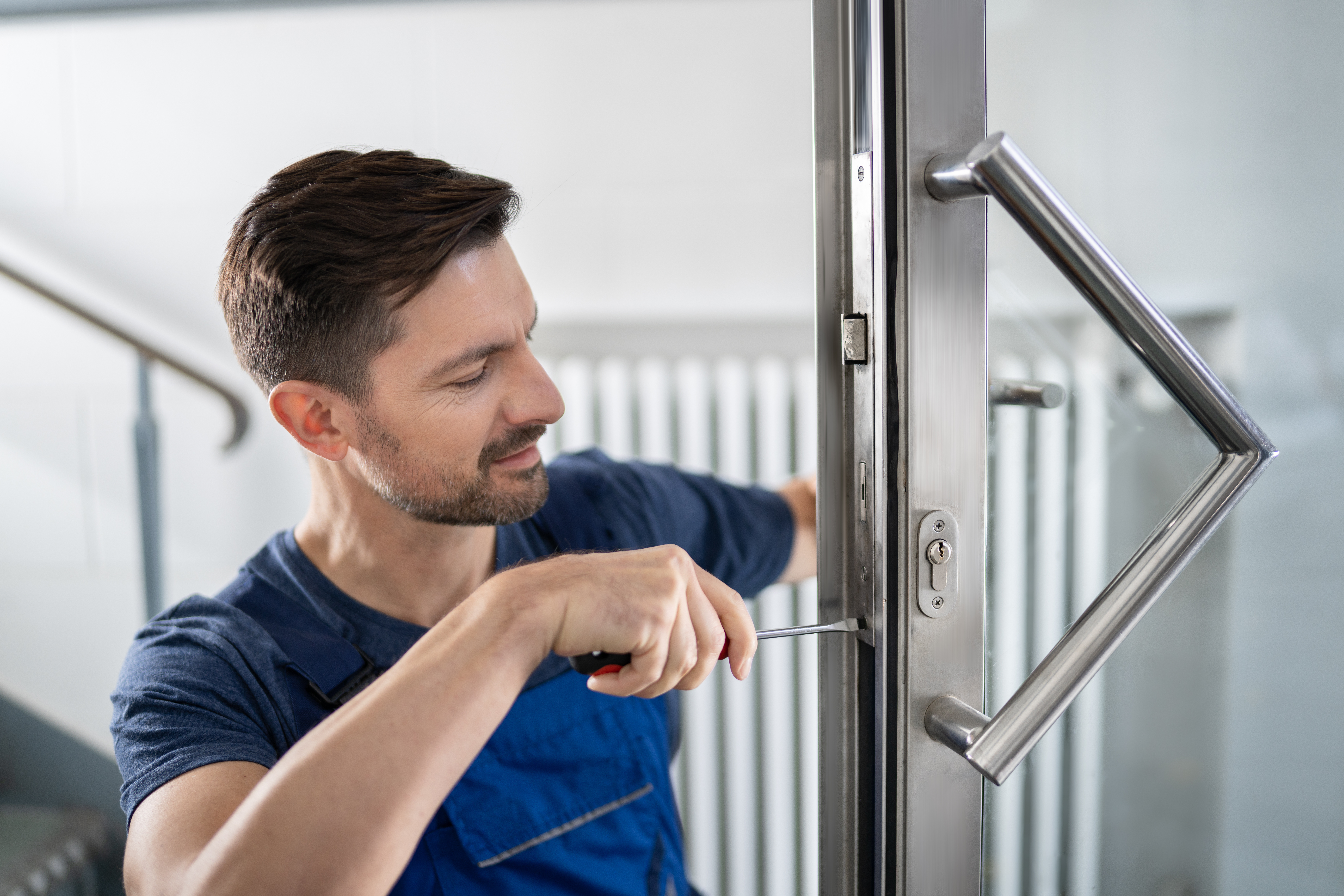 Handwerker beim Einbau eines neuen Türschloss